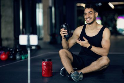 Fitness And Nutrition Products. Arab Athlete Advertising Sport Shaker Bottle At Camera