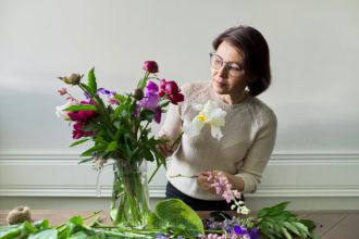 Mature woman at home with spring flowers